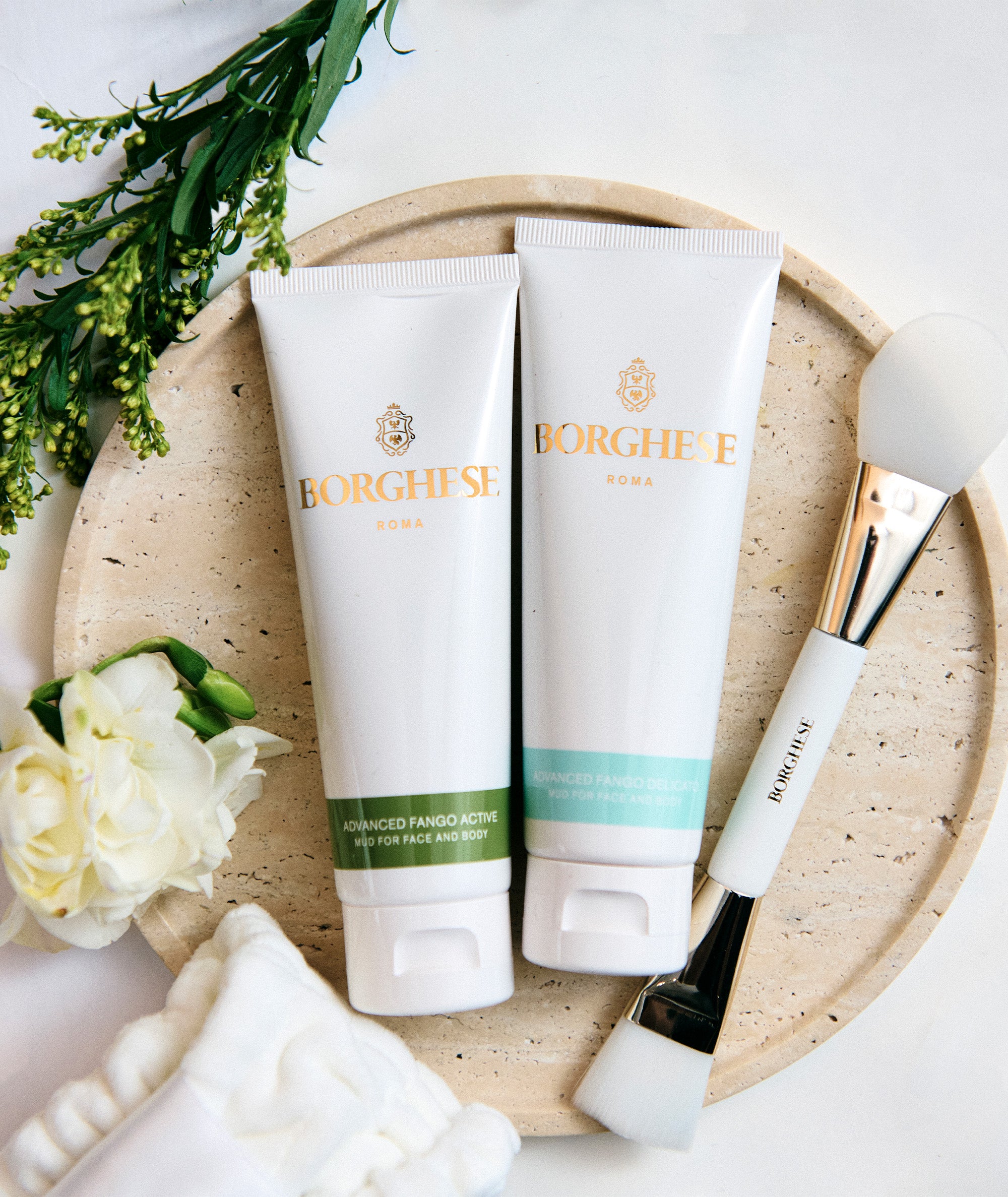 Lifestyle shot of our Advanced Fango Acrive and Advanced Fango Delicato travel size tubes
