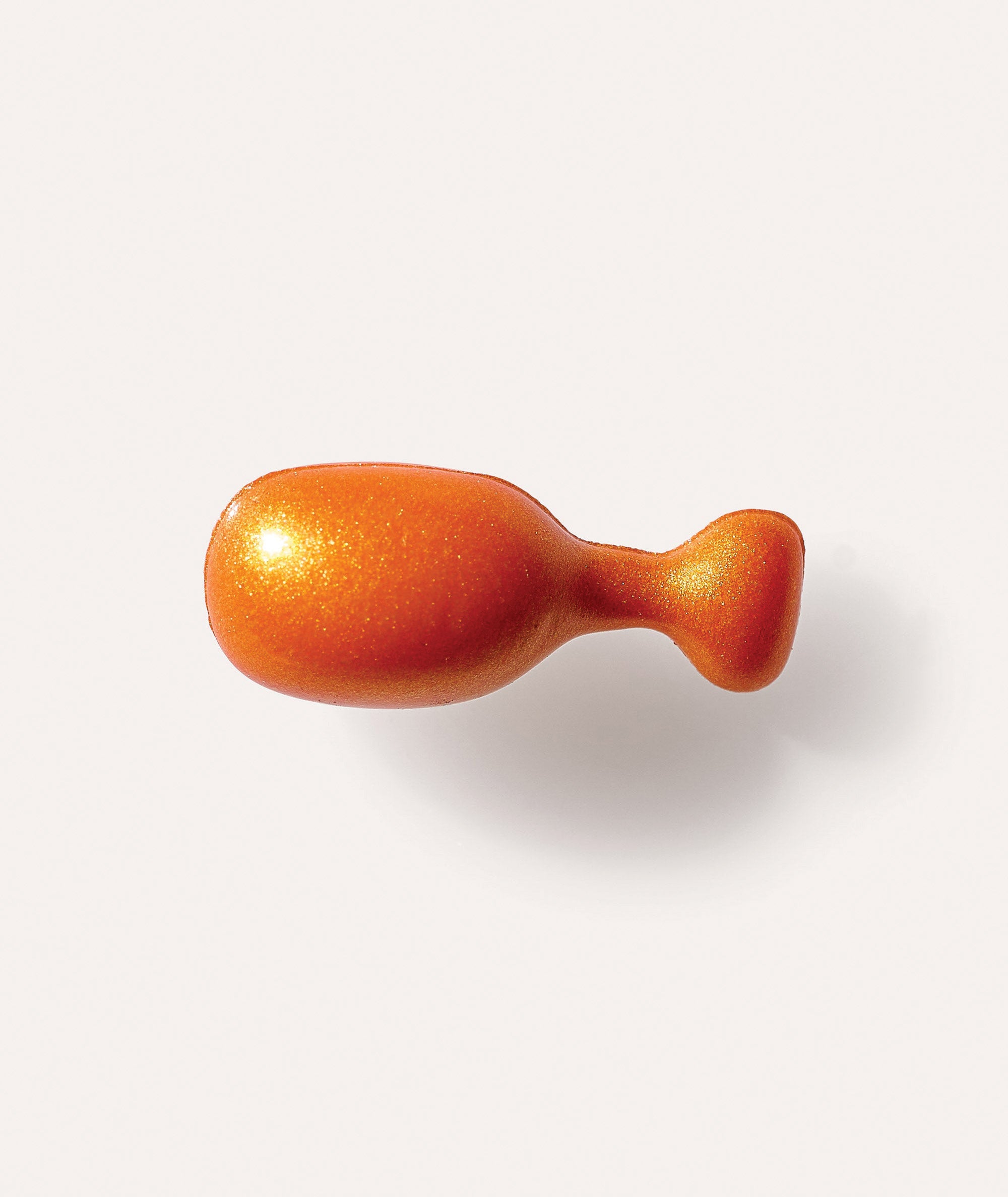 Closeup of single orange Power-C capsule