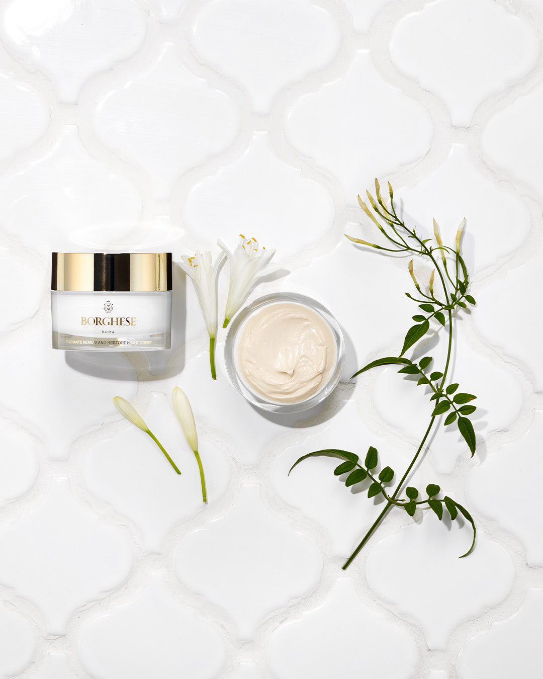 Product shot with ingredients of Radiante Renew and Restore Night Creme showing Night Jasmine and Tamarind extracts