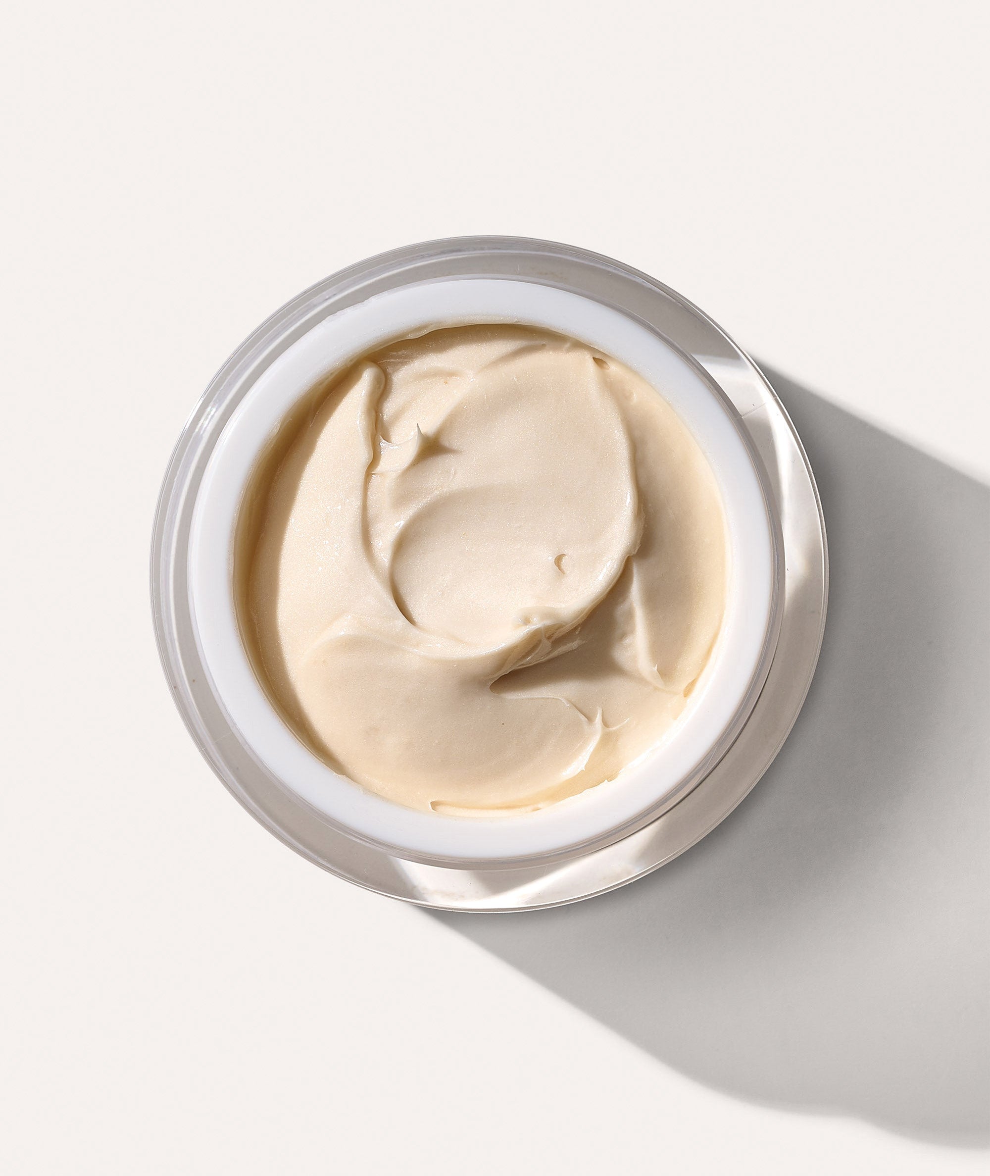 Aeiral view of jar open showing the texture of our Radinate Renew and Restore Night Creme