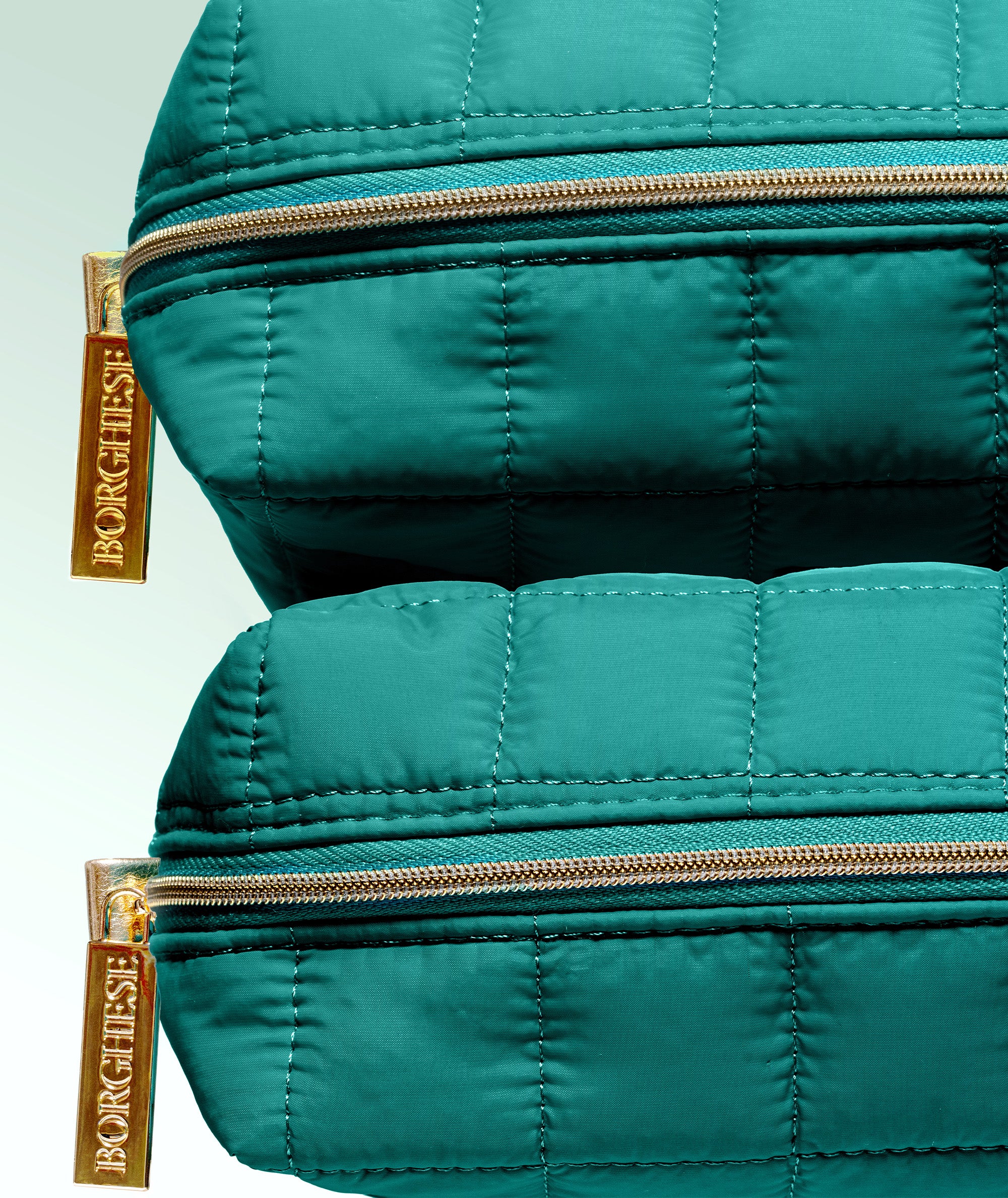 A closeup of our gold Borghese zipper for the Spa Lift for Eyes Set bag in Bagno blue