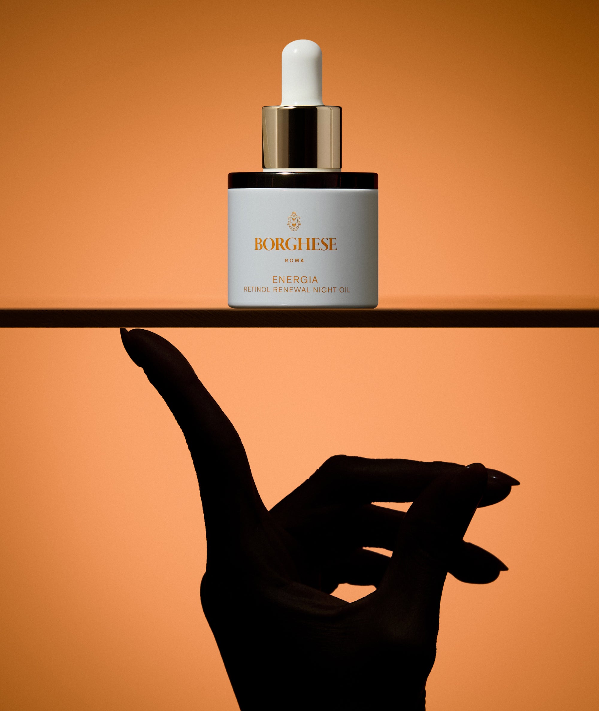 Product shot of ENERGIA Retinol Renewal Night Oil with model