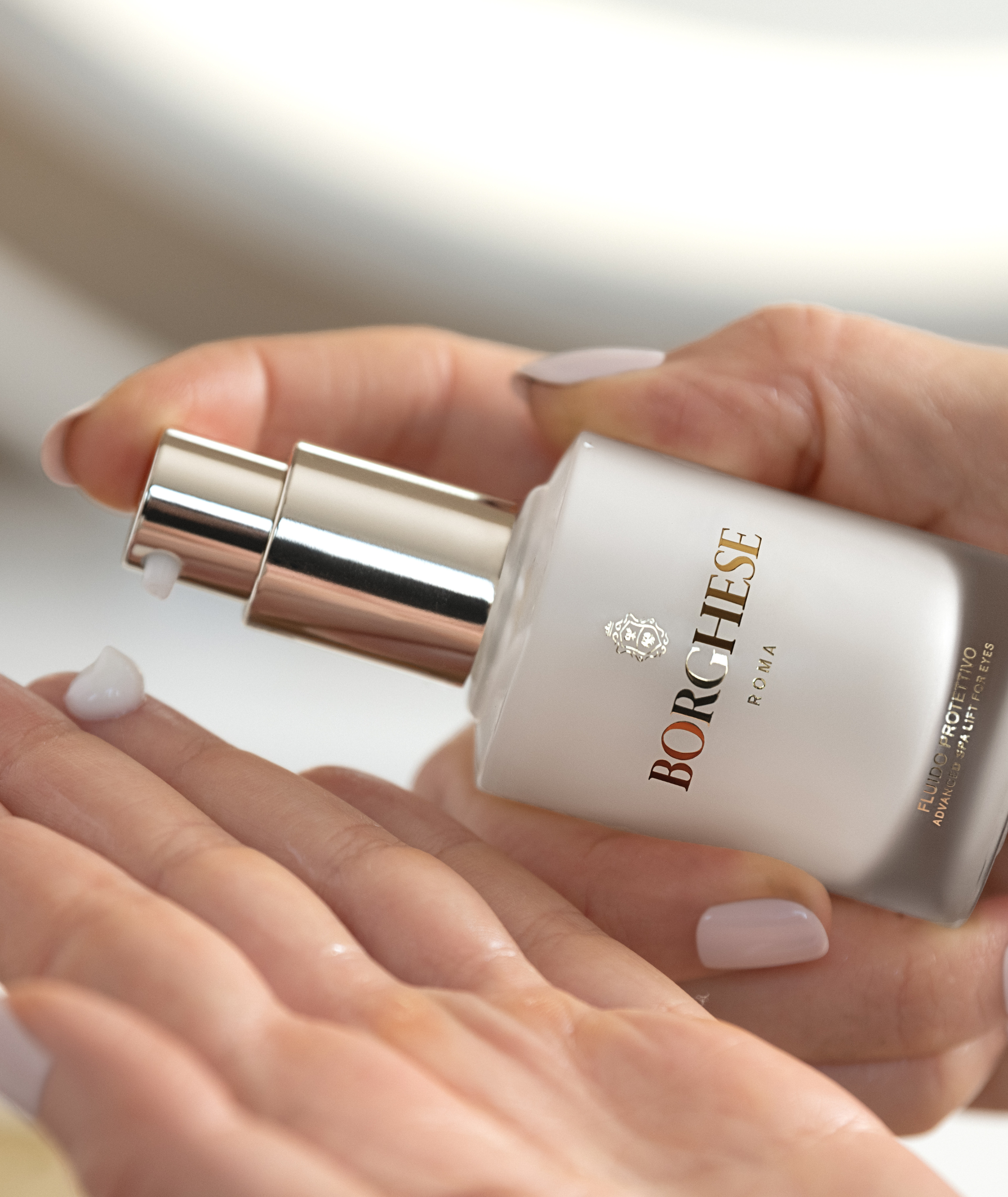 A closeup of the product being pumped out of the bottle.