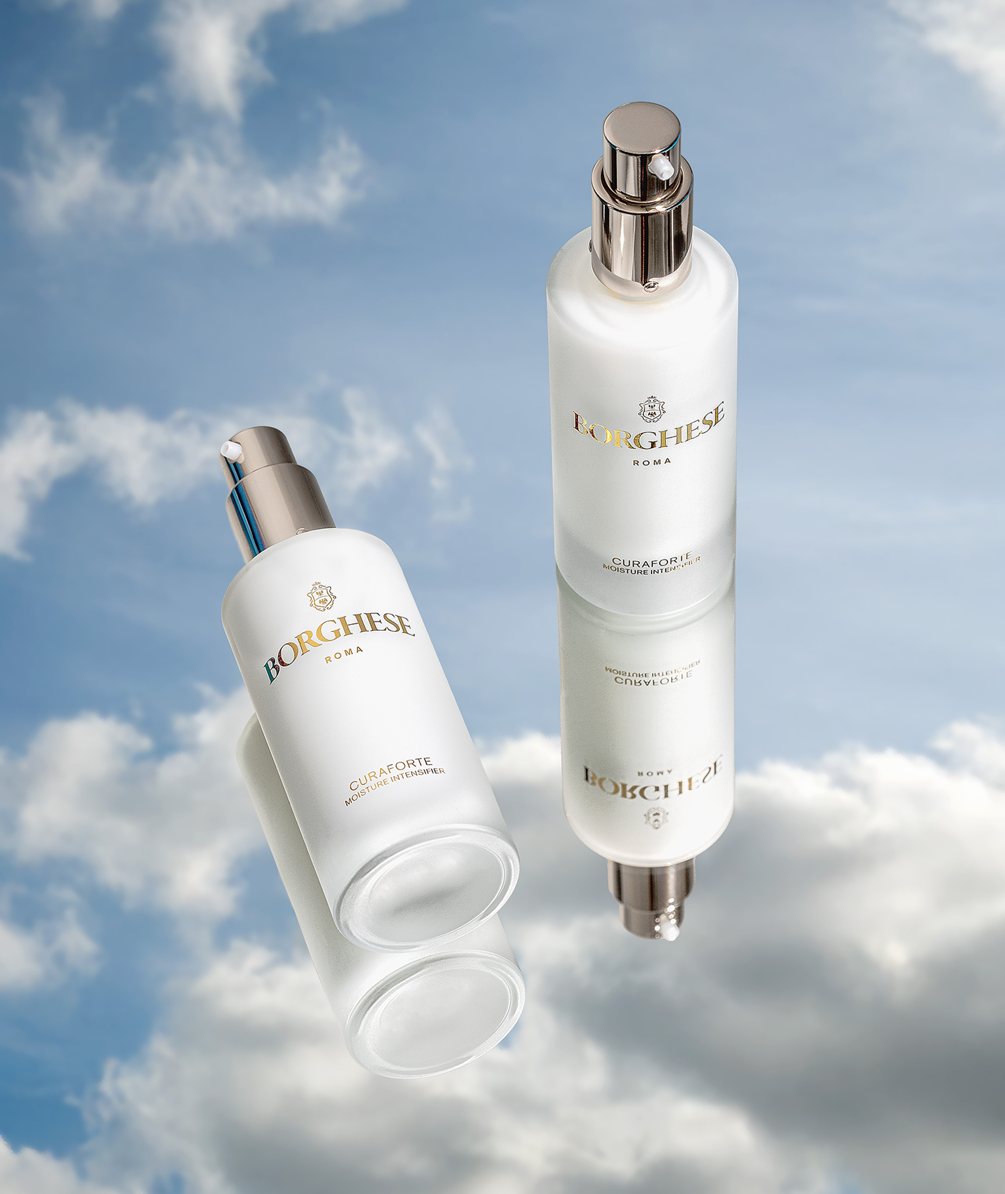 Product image of two Curaforte Moisture Intensifier products standing and laying down on a mirror reflecting the sky