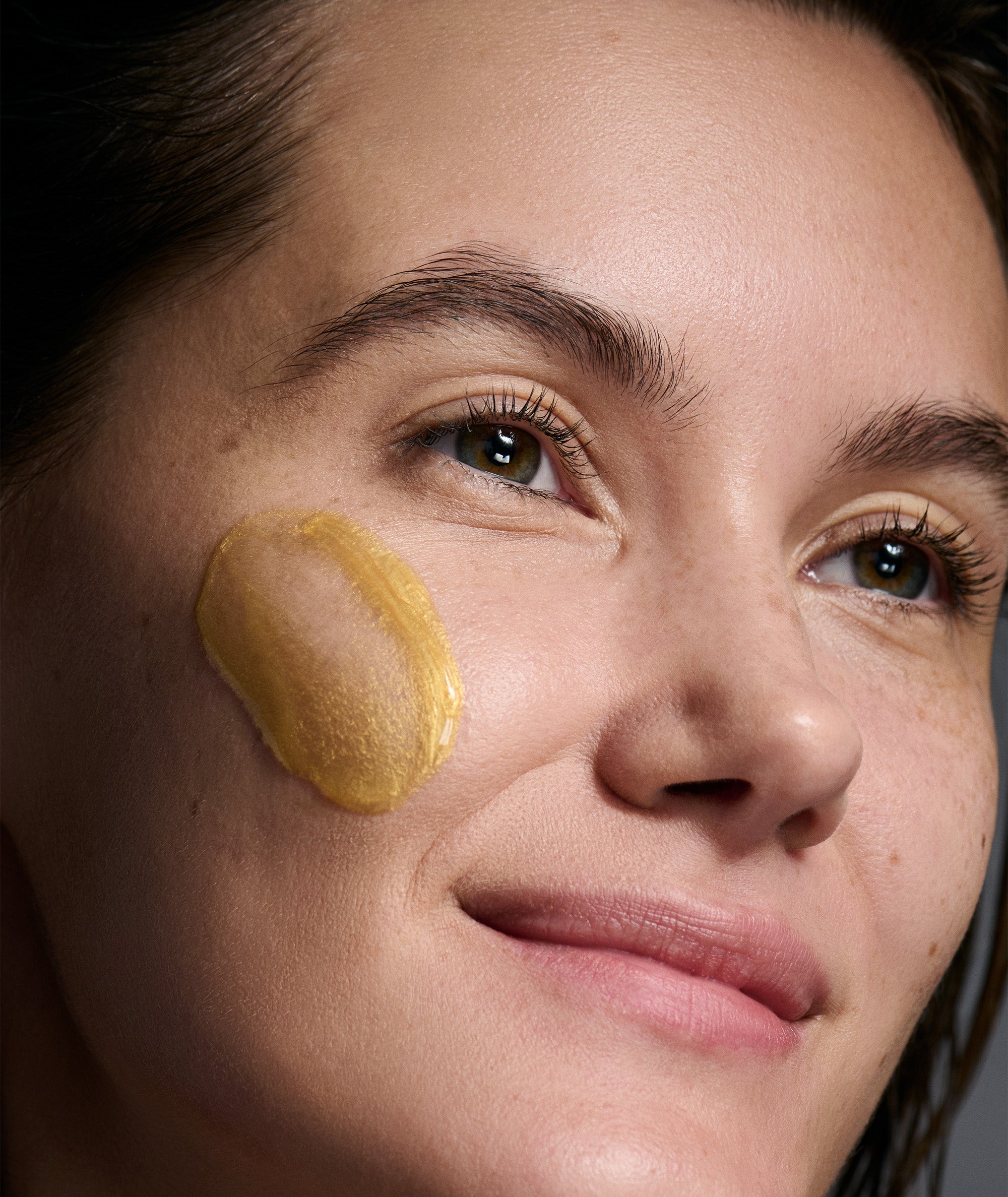 A closeup shot of a model with the Radiante Revitalize and Firm Mask applied. 